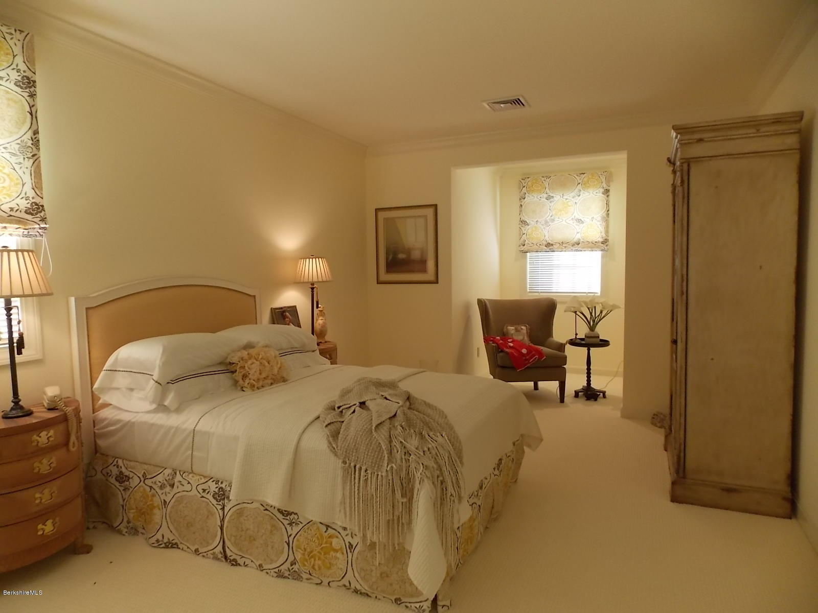 18 High Crest Road, Unit 18 Lenox, MA 01240 - Photo 23 of 34 a bedroom with a bed and chair