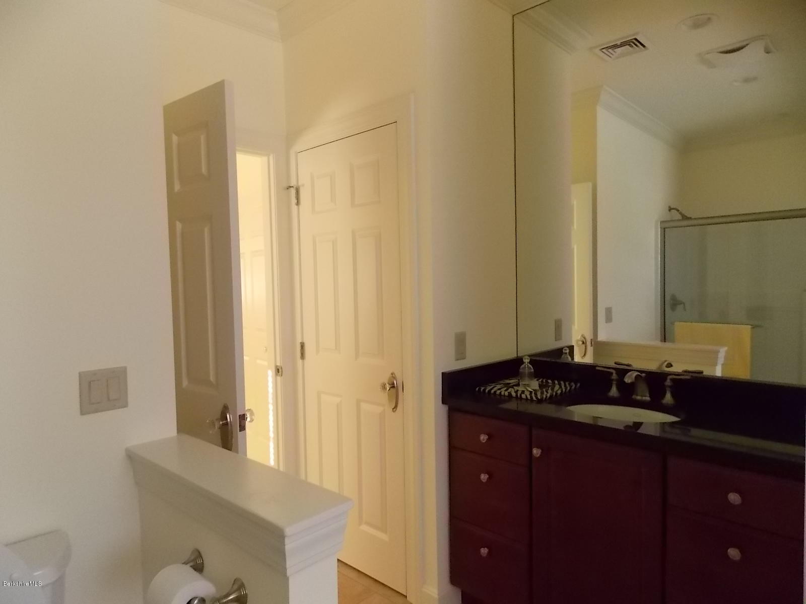 18 High Crest Road, Unit 18 Lenox, MA 01240 - Photo 24 of 34 a bathroom with a granite countertop sink and a mirror