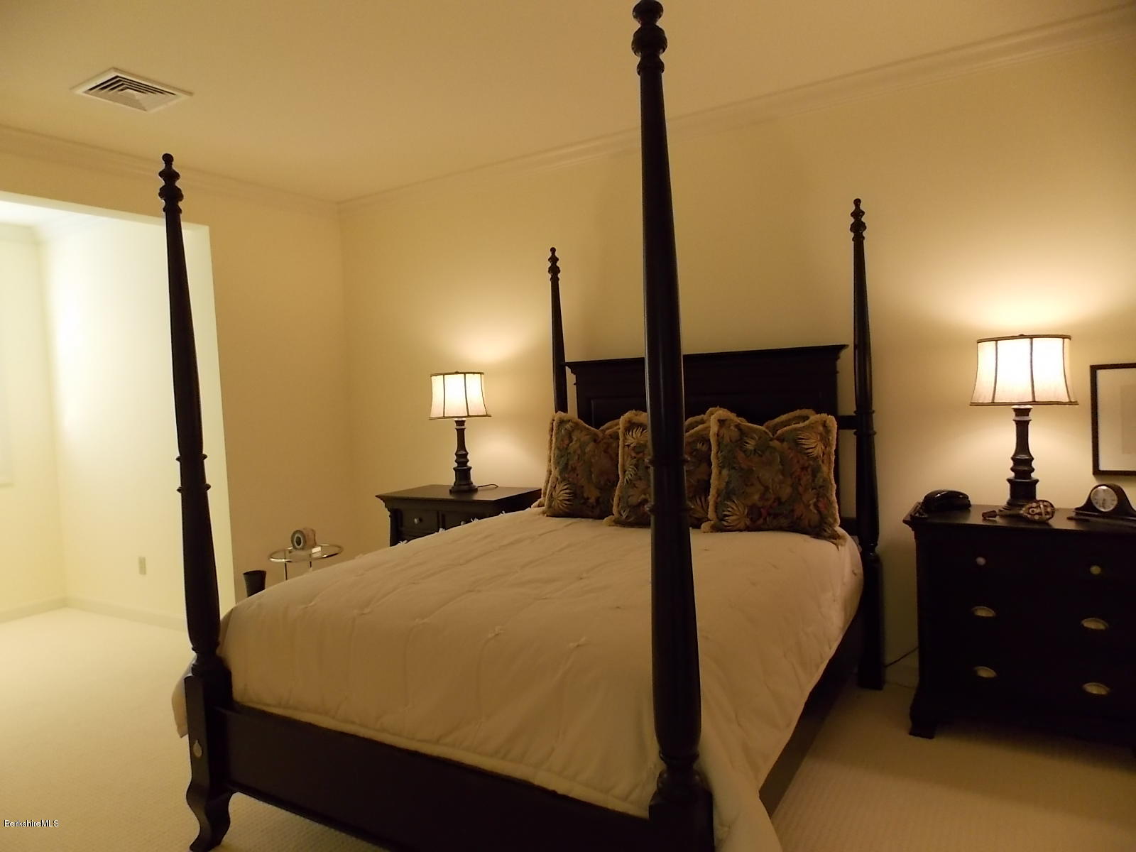 18 High Crest Road, Unit 18 Lenox, MA 01240 - Photo 26 of 34 a bed sitting in a bedroom next to a window