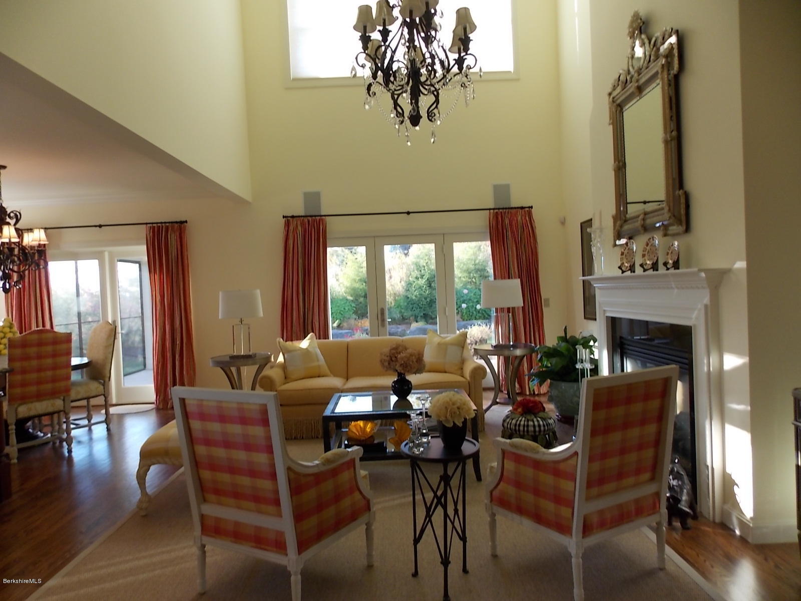 18 High Crest Road, Unit 18 Lenox, MA 01240 - Photo 6 of 34 a living room with furniture a fireplace and a floor to ceiling window