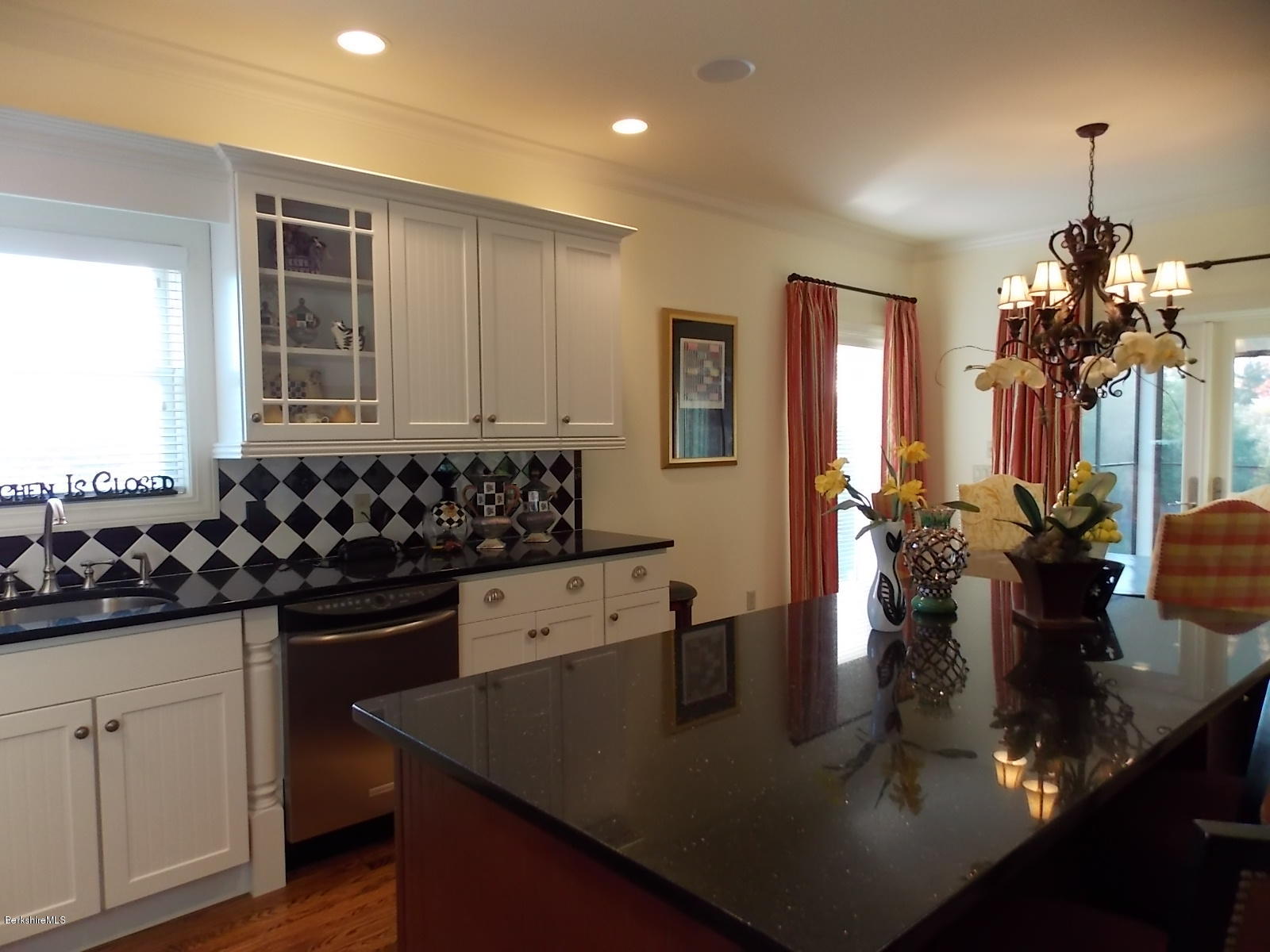 18 High Crest Road, Unit 18 Lenox, MA 01240 - Photo 9 of 34 a kitchen with kitchen island granite countertop a sink a stove and cabinets