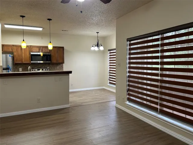 a kitchen with stainless steel appliances granite countertop a sink and a refrigerator
