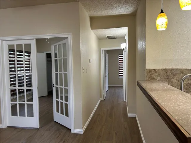 a view of a kitchen from the hallway