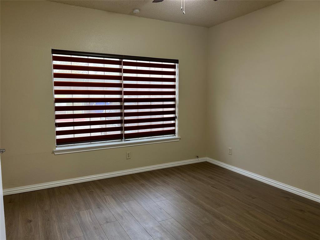 4101 Esters Road, Unit 101 Irving, TX 75038 - Photo 9 of 11 an empty room with wooden floor and a window