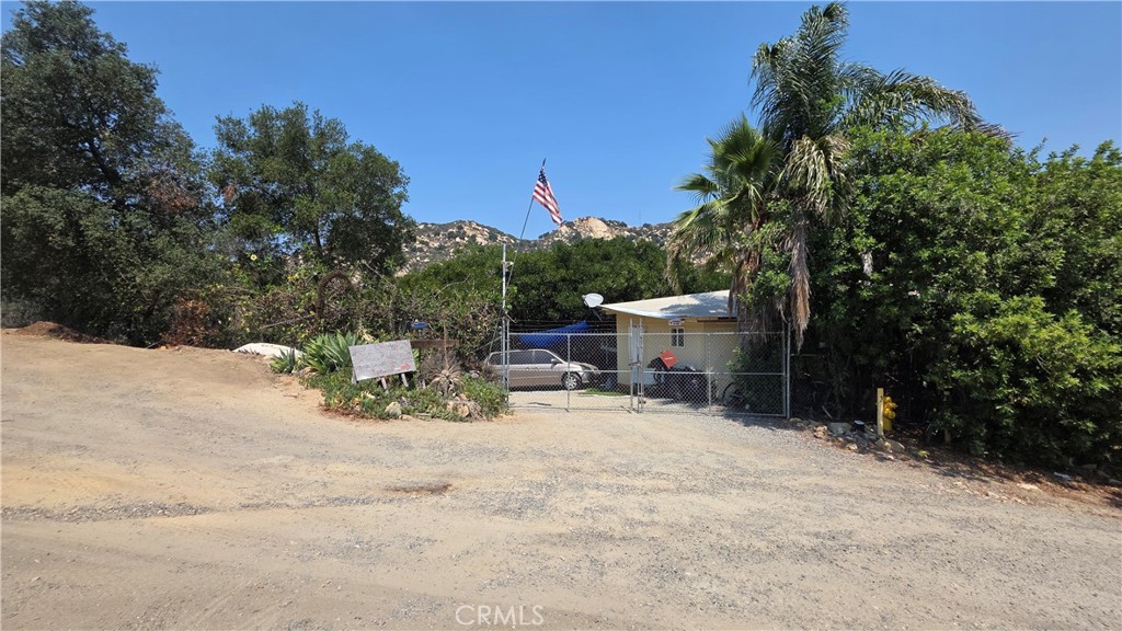 3027 Rainbow Valley Boulevard Fallbrook, CA 92028 - Photo 2 of 7 a view of backyard with a table and chairs under an umbrella