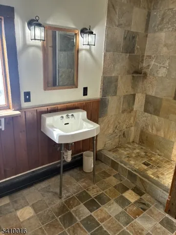 a bathroom with a sink a toilet and a mirror
