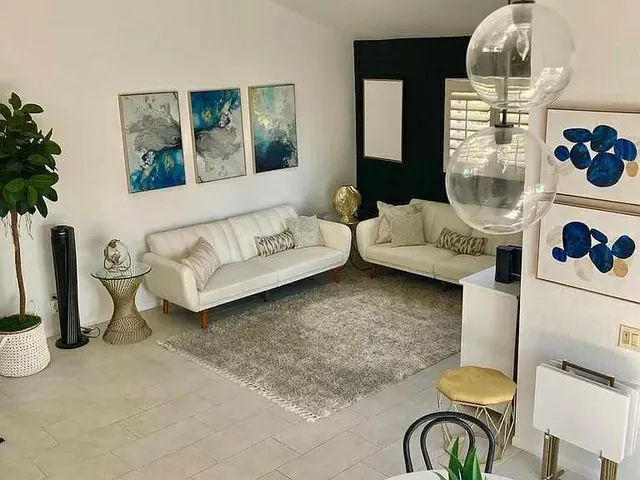 a living room with furniture and a chandelier