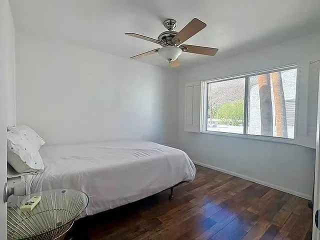 a bedroom with a bed and window