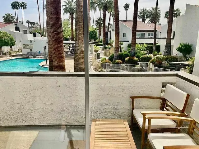 a view of balcony with chairs and potted plants