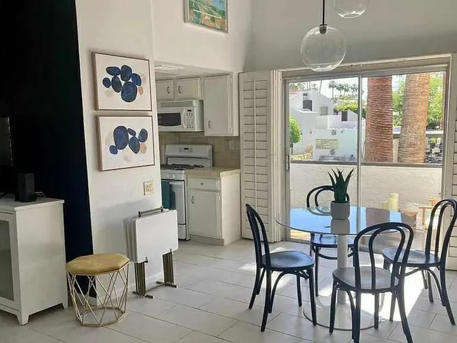a dining room with furniture and window