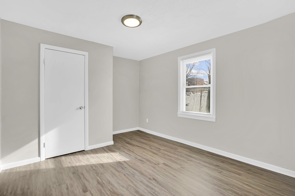 21 Depot Street Chicopee, MA 01013 - Photo 11 of 31 an empty room with wooden floor and windows
