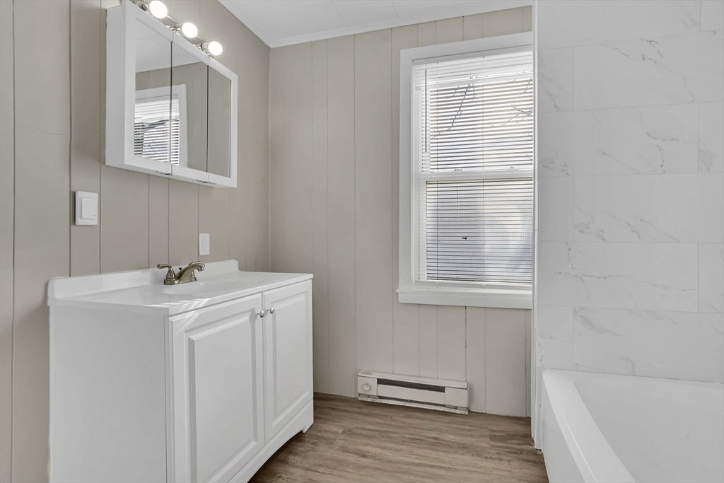 21 Depot Street Chicopee, MA 01013 - Photo 14 of 31 a bathroom with a sink a vanity and a bathtub