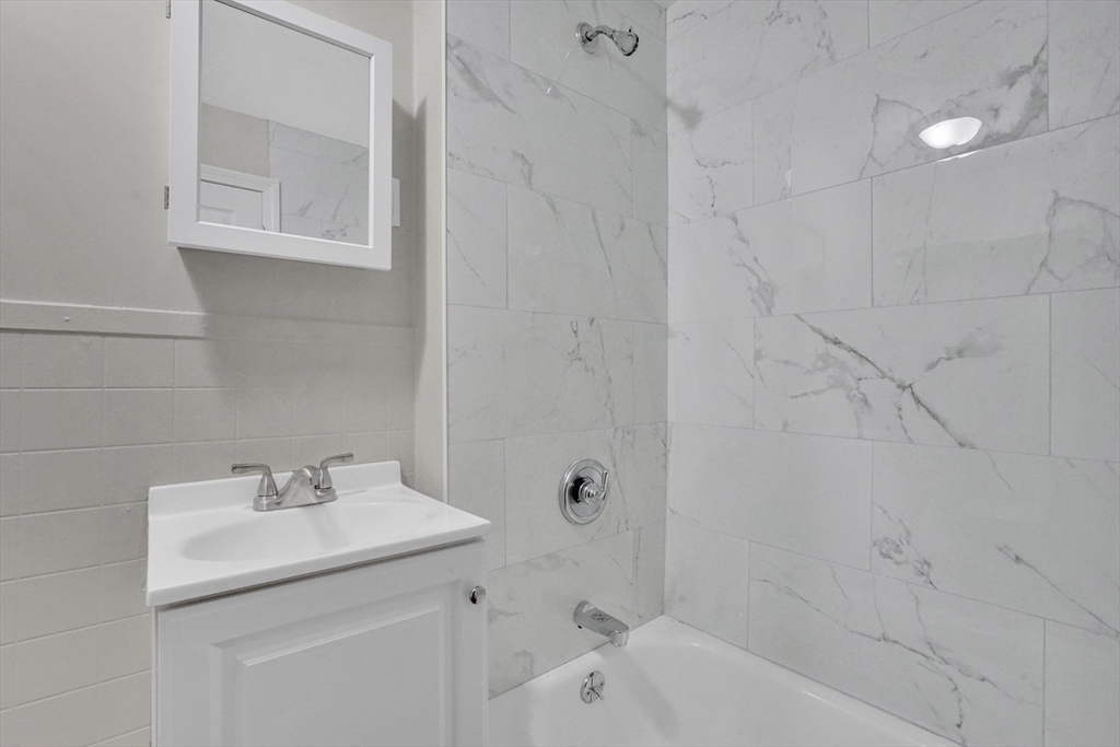 21 Depot Street Chicopee, MA 01013 - Photo 18 of 31 a bathroom with a sink a toilet and shower