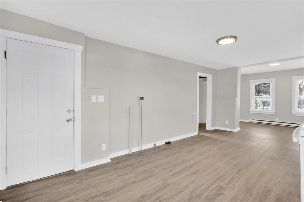 21 Depot Street Chicopee, MA 01013 - Photo 4 of 31 a view of an empty room with wooden floor and a window