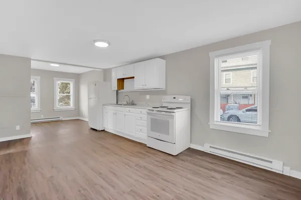 a view of kitchen with cabinets and wooden floor