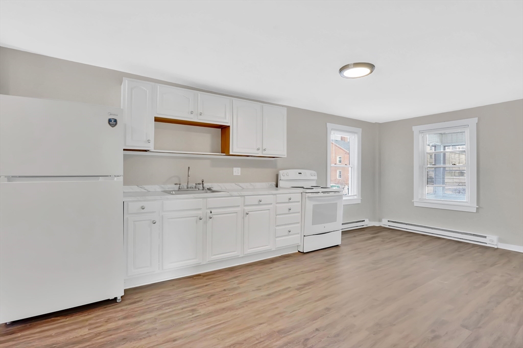 21 Depot Street Chicopee, MA 01013 - Photo 6 of 31 a kitchen with granite countertop white cabinets and wooden floor