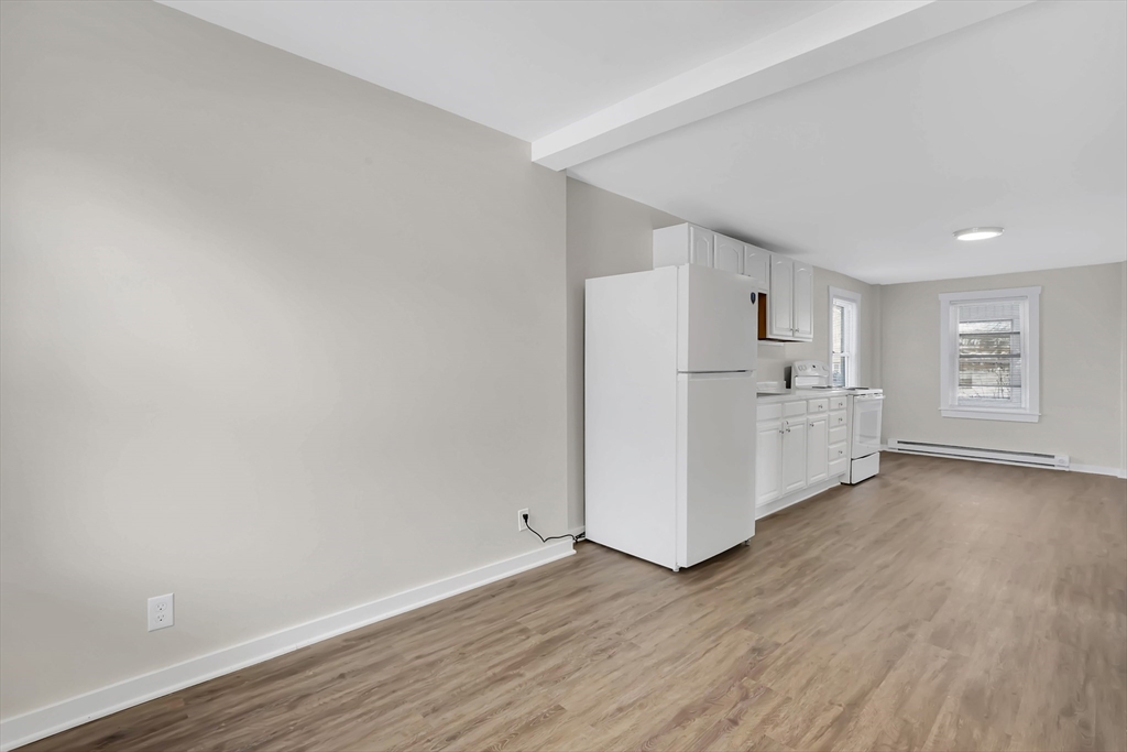 21 Depot Street Chicopee, MA 01013 - Photo 9 of 31 a view of a kitchen with wooden floor and electronic appliances