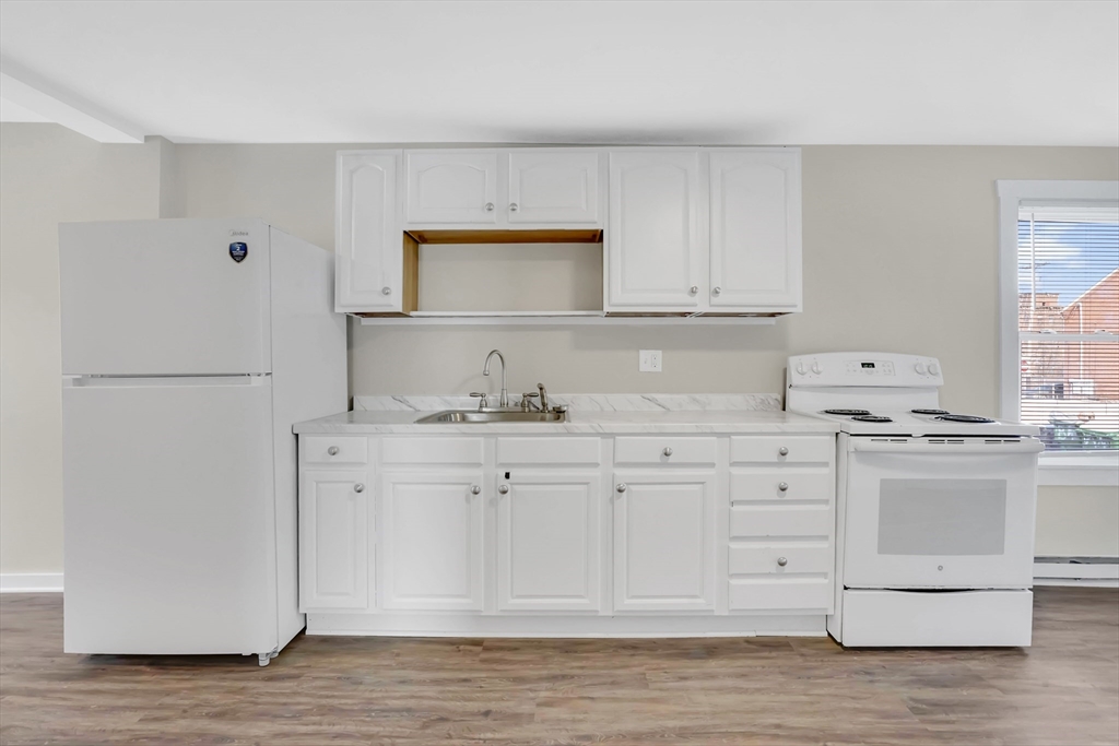 21 Depot Street Chicopee, MA 01013 - Photo 10 of 31 a kitchen with granite countertop white cabinets and white appliances
