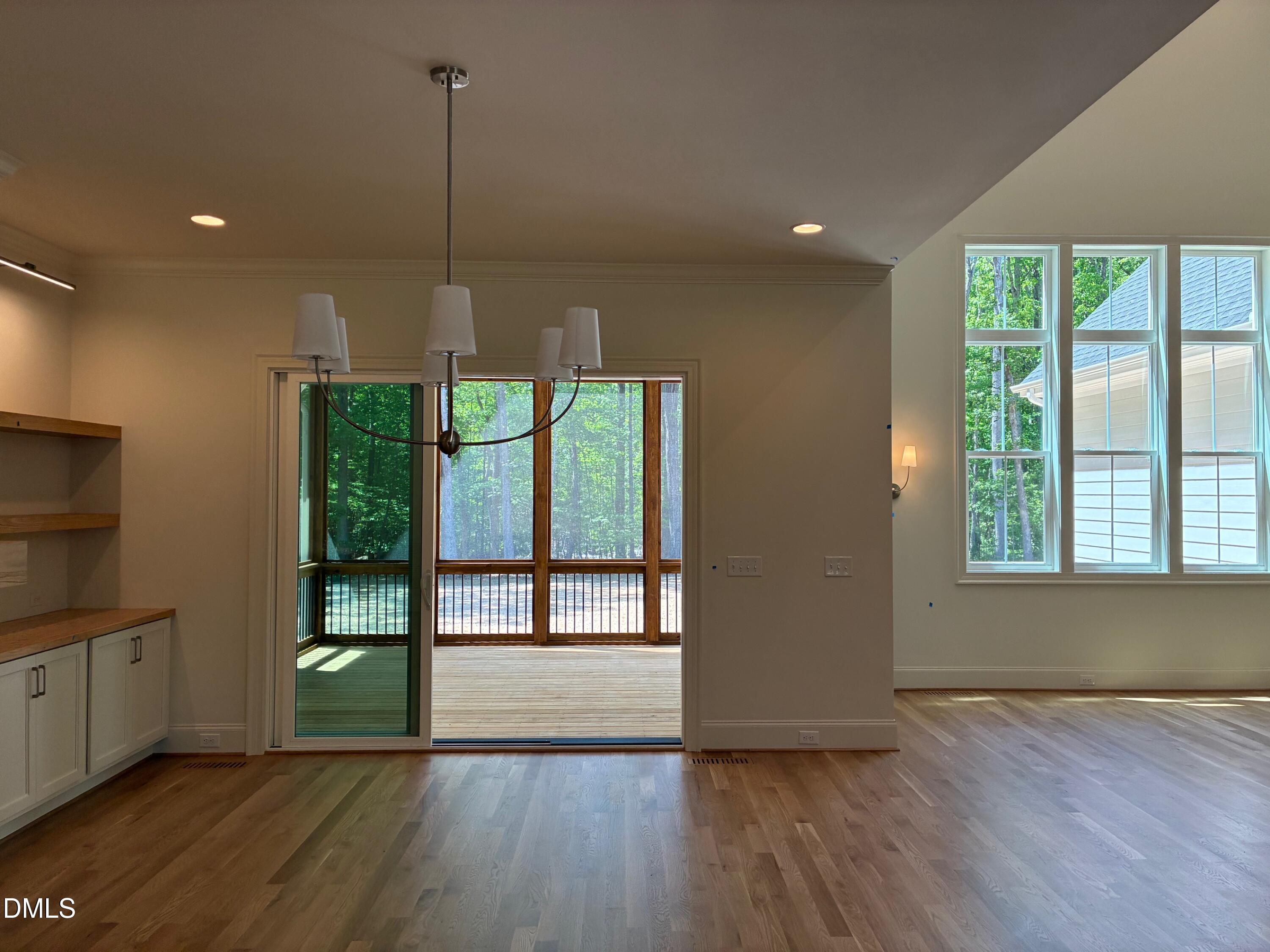 638 Old Goldston Road Pittsboro, NC 27312 - Photo 12 of 28 a view of an empty room with a window and wooden floor