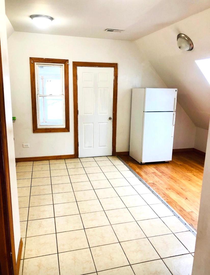 1828 North Pulaski Road, Unit 2 Chicago, IL 60639 - Photo 5 of 6 a view of an empty room with a window