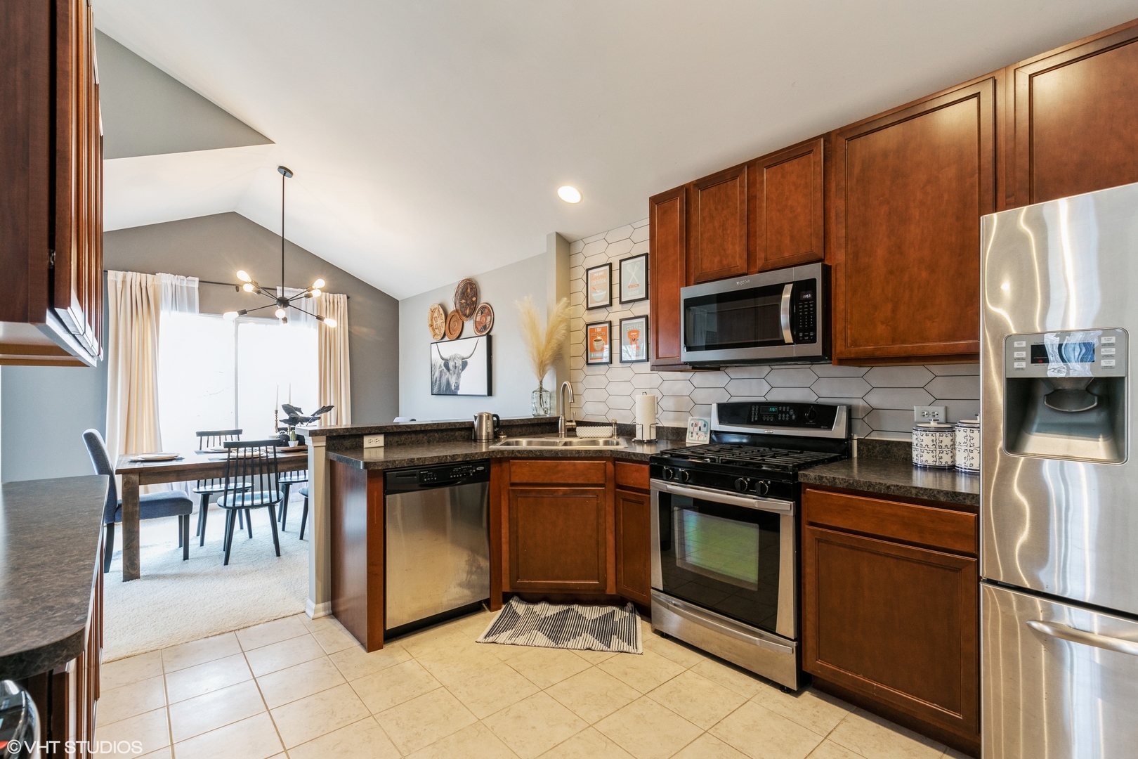 3340 Cameron Drive Elgin, IL 60124 - Photo 5 of 18 a kitchen with granite countertop a stove top oven microwave and cabinets