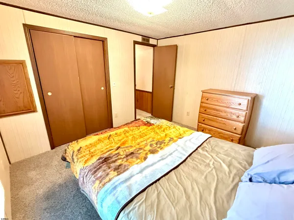 a bedroom with a bed and a mirror