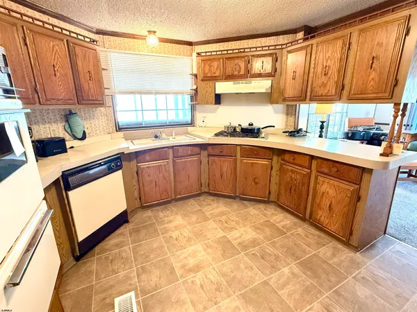 a kitchen with stainless steel appliances granite countertop a stove sink and cabinets