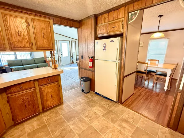 a kitchen with stainless steel appliances granite countertop a refrigerator a stove a sink and with a dining table