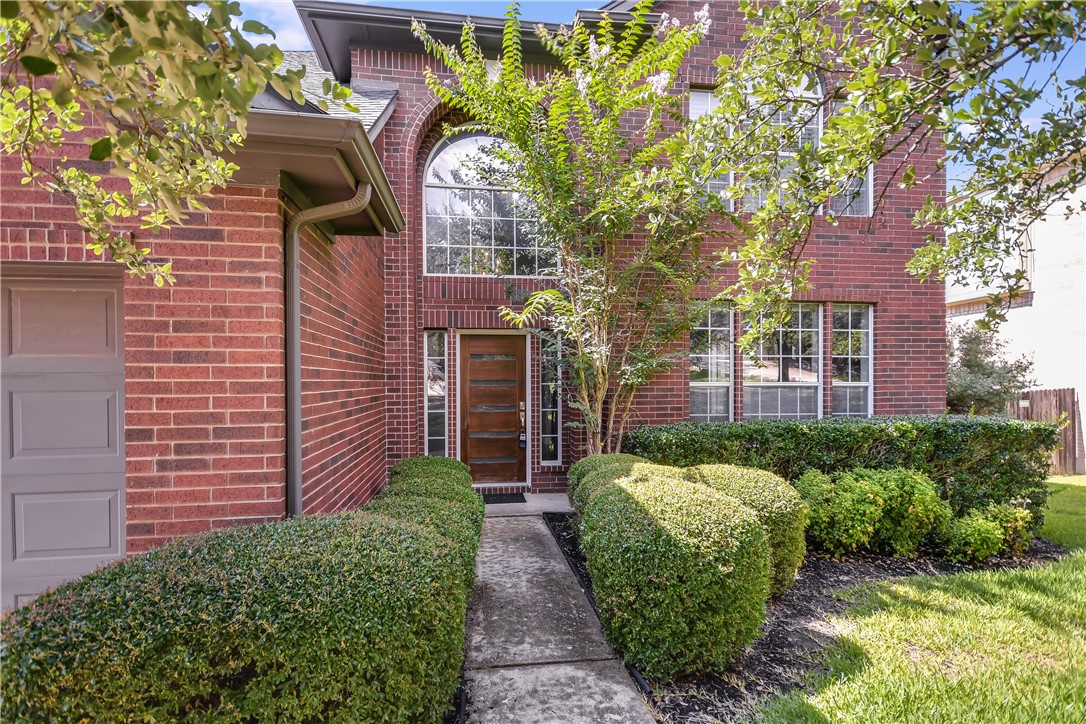 3513 Grimes Ranch Road Austin, TX 78732 - Photo 2 of 32 Property entrance with brick siding and an attached garage