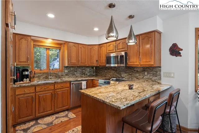 a kitchen with a sink a counter top space and appliances