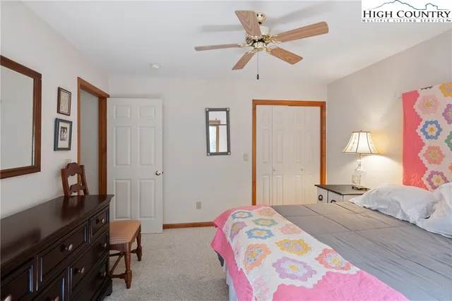 a bedroom with a bed dresser and a window