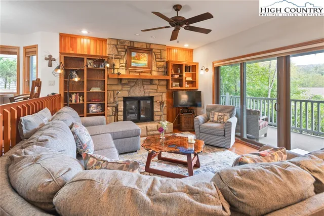 a living room with furniture and a floor to ceiling window