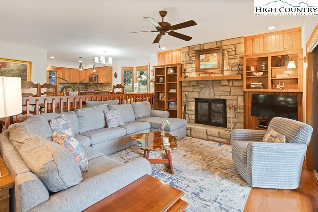a living room with furniture kitchen view and a fireplace