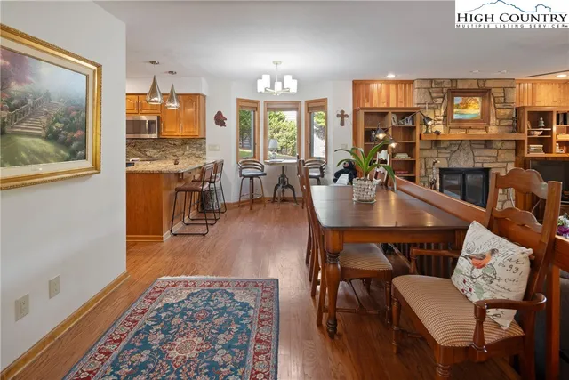 a dining room with furniture and wooden floor