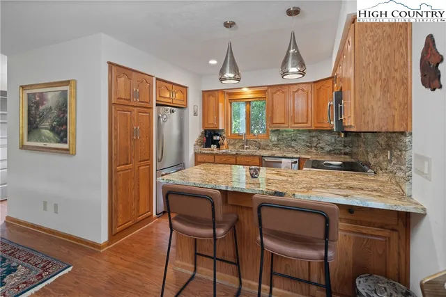 a kitchen with granite countertop a sink cabinets and window
