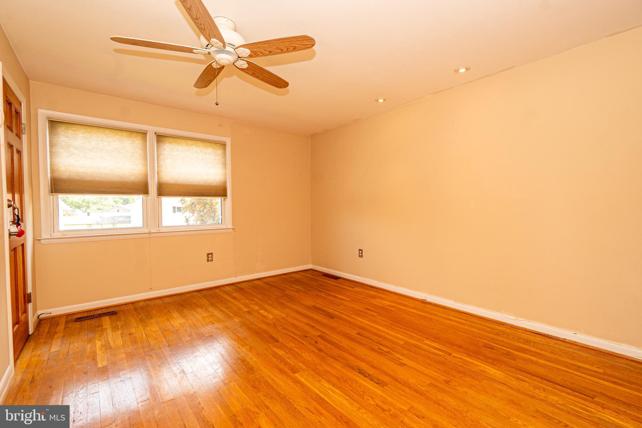 4523 Hawksbury Road Baltimore, MD 21208 - Photo 16 of 35 an empty room with a window and ceiling fan