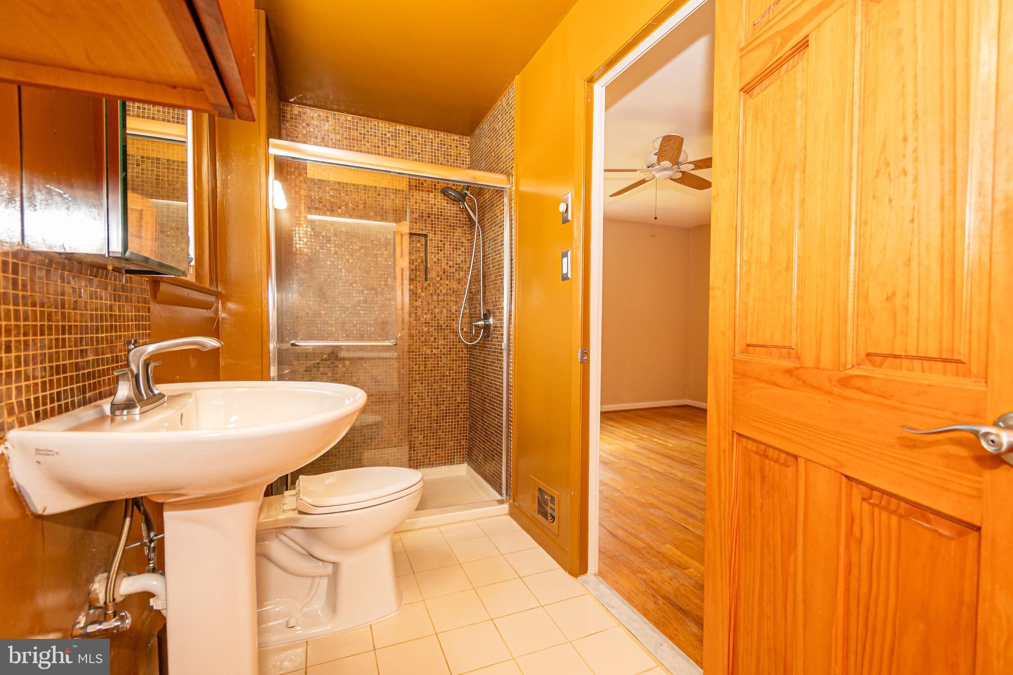 4523 Hawksbury Road Baltimore, MD 21208 - Photo 17 of 35 a bathroom with a sink a toilet and shower