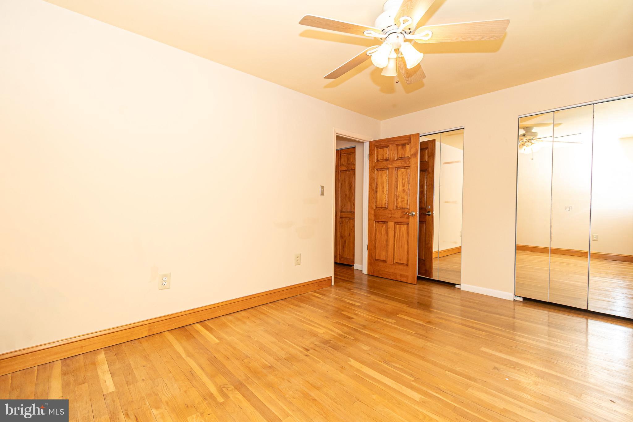 4523 Hawksbury Road Baltimore, MD 21208 - Photo 20 of 35 a view of an empty room with window and a ceiling fan