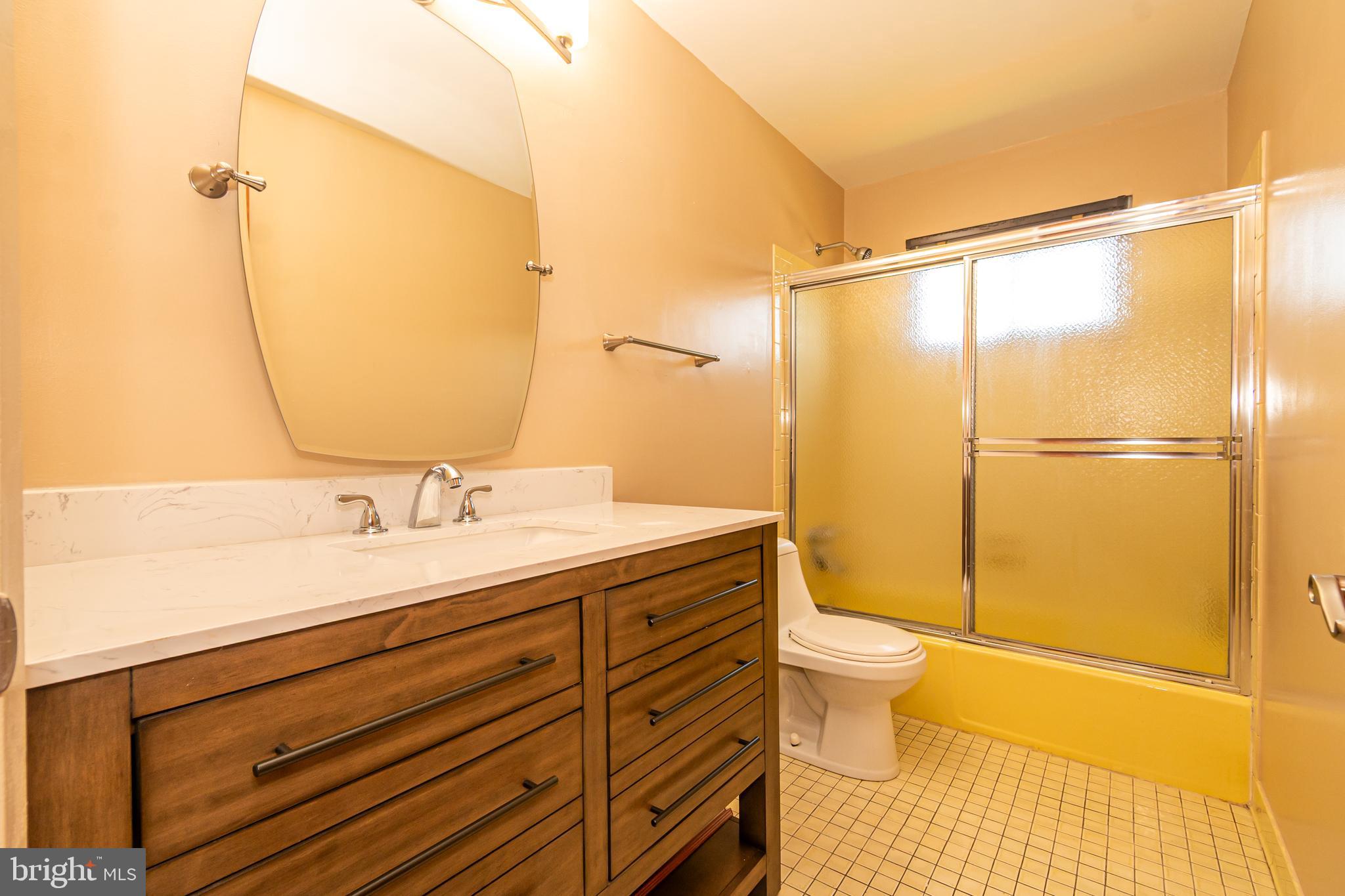 4523 Hawksbury Road Baltimore, MD 21208 - Photo 21 of 35 a bathroom with a granite countertop sink toilet and shower