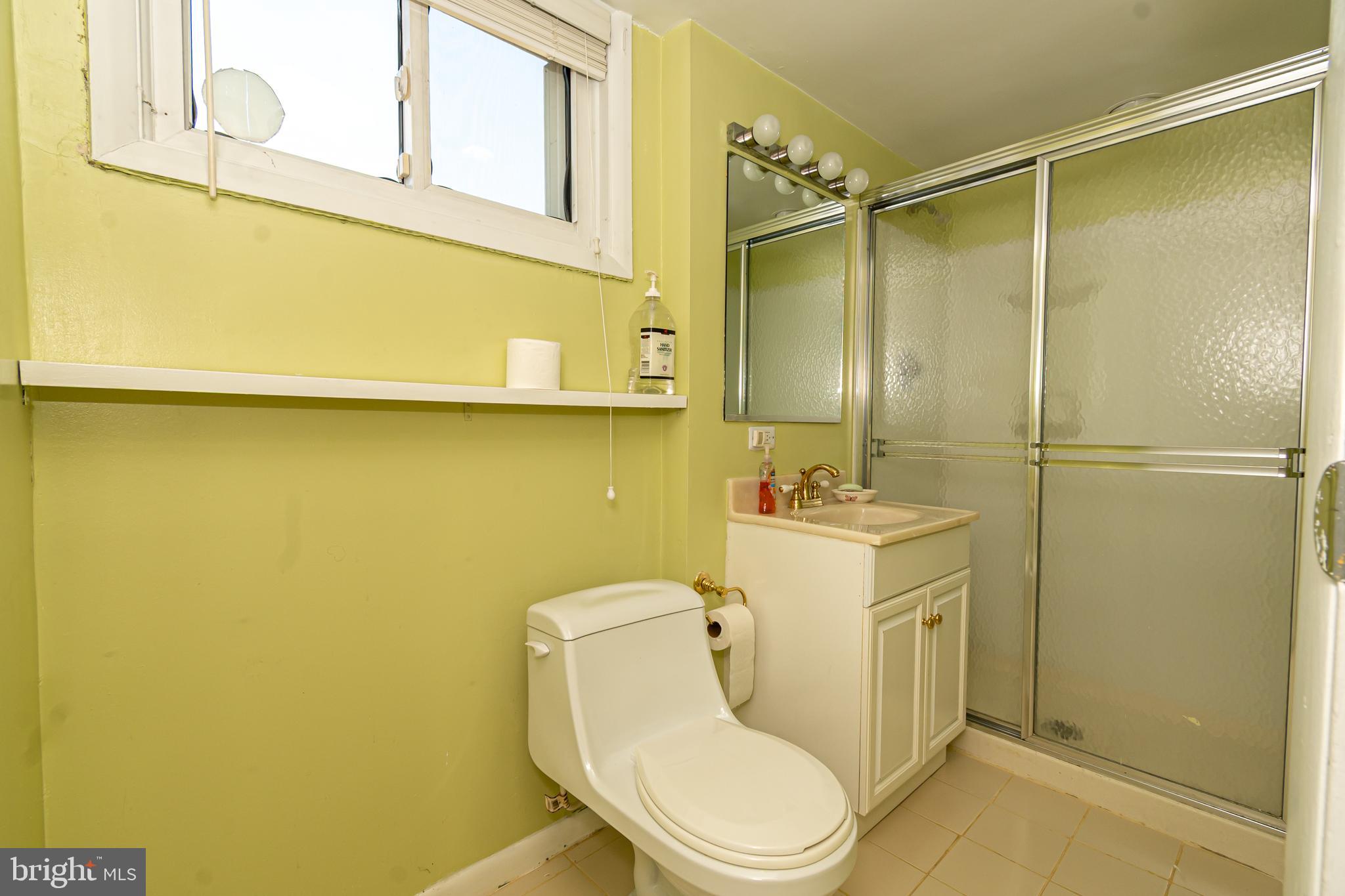 4523 Hawksbury Road Baltimore, MD 21208 - Photo 24 of 35 a bathroom with a toilet sink vanity and shower