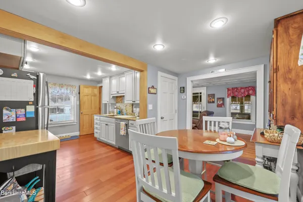a dining room with furniture and wooden floor