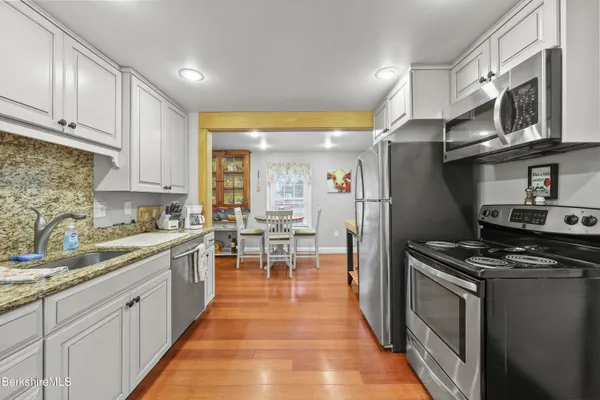 a kitchen with stainless steel appliances a stove a sink and a refrigerator