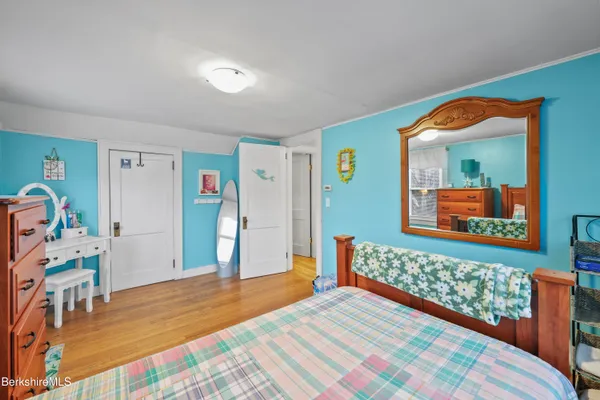 a bedroom with a bed and a dresser in it