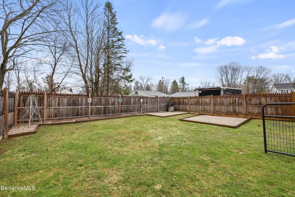 a view of a garden with wooden fence