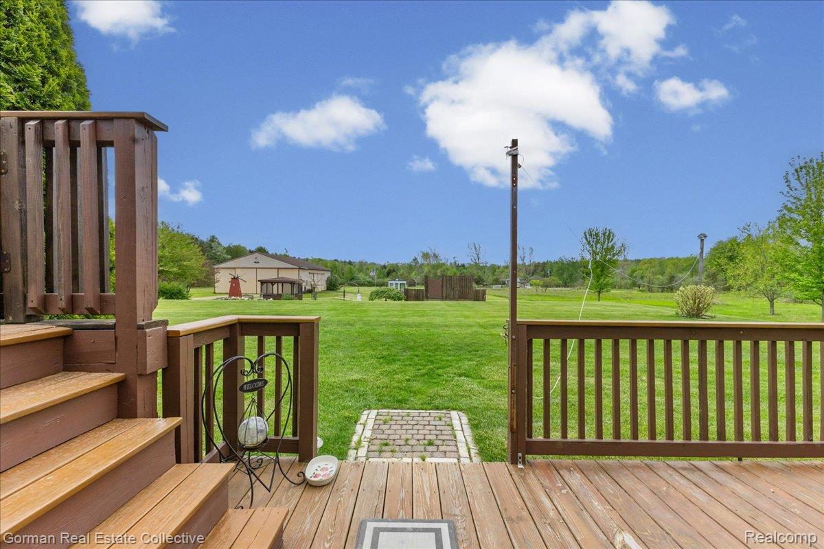 3457 West Burnside Road Columbiaville, MI 48421 - Photo 27 of 45 Wooden deck featuring a yard