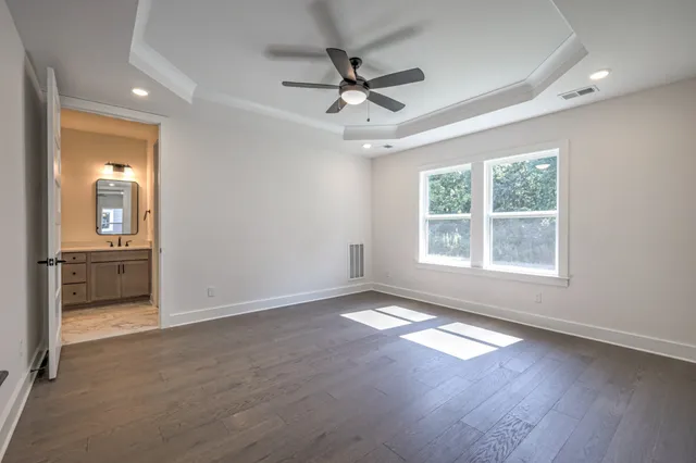 an empty room with a ceiling fan and a window