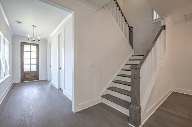 a view of a hallway with wooden floor