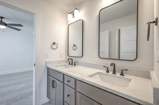 an empty room with closet and a ceiling fan