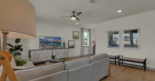 a living room with furniture and a chandelier