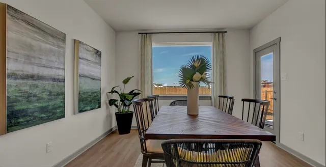 a view of a dining room with furniture window and wooden floor